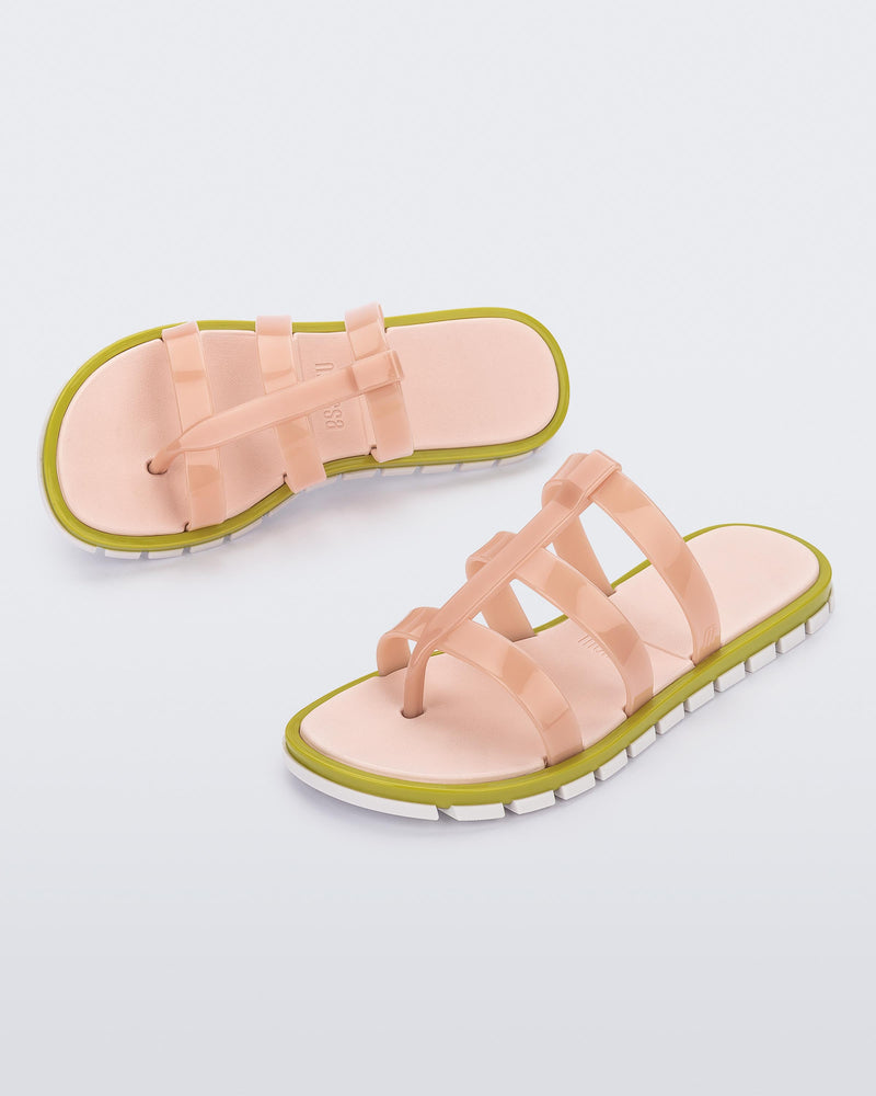 Top and angled view of a pair of pink Path adult sandals with green sole