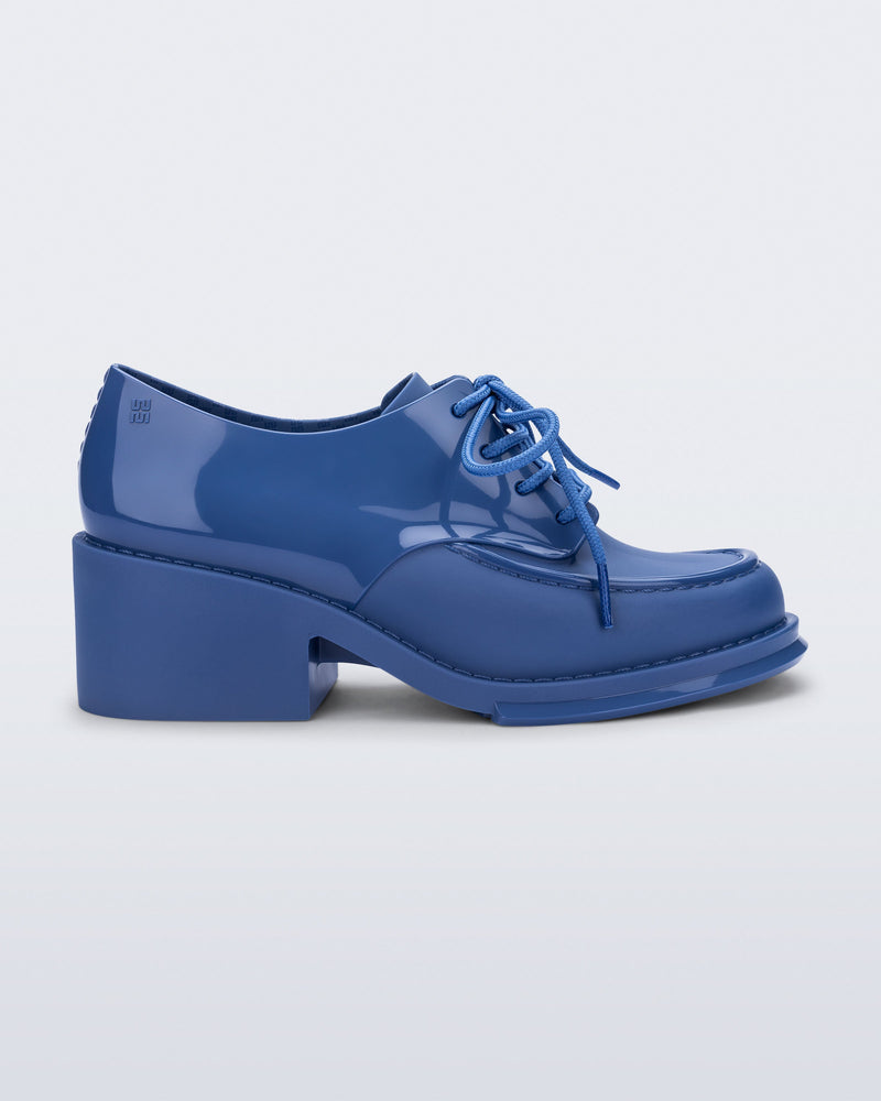 Side view of a blue Tailor loafer with laces