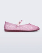 Side view of a clear pink Harper flat with strap