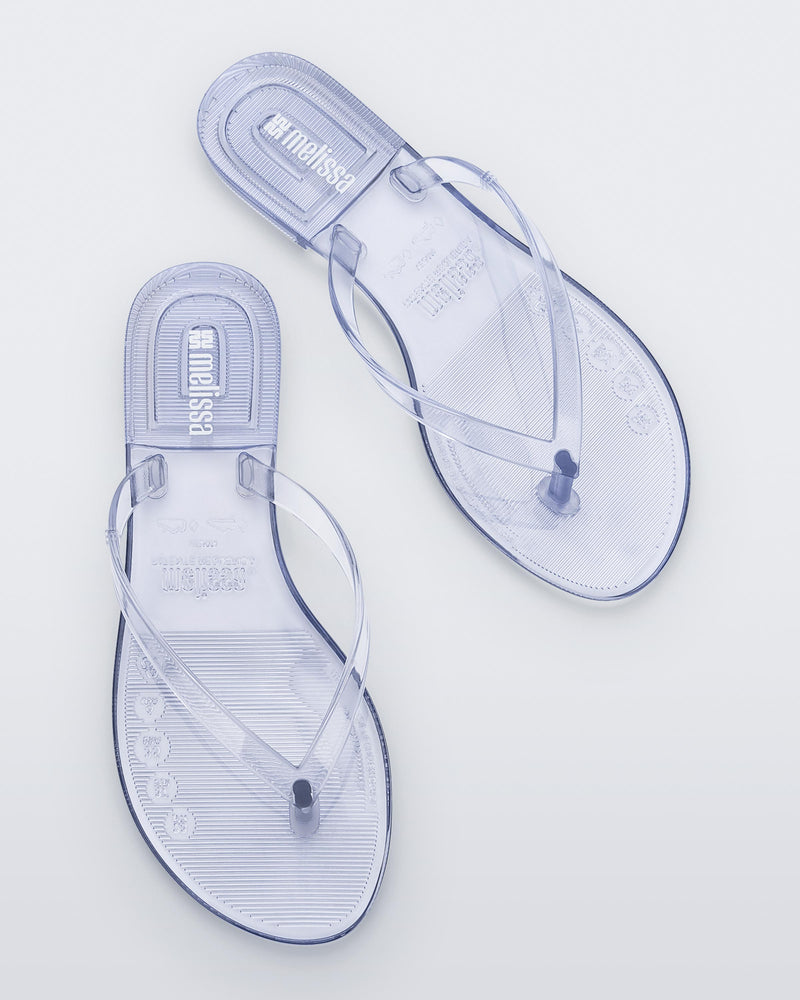 Top view of a pair of clear Harmonic Jelly flip flops