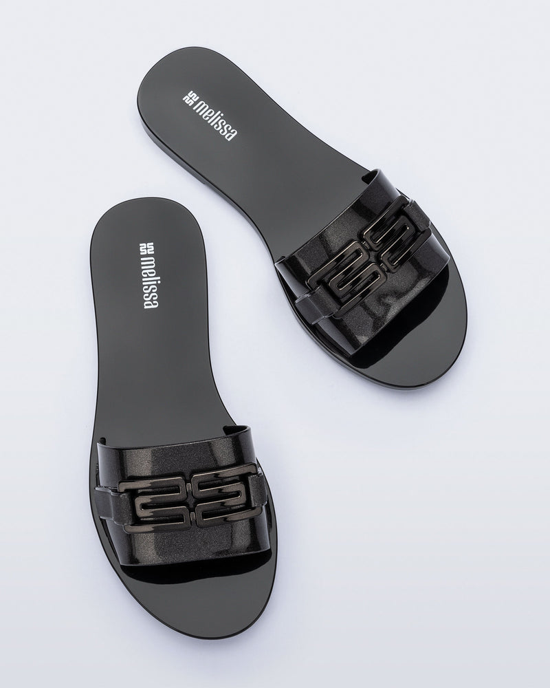 Top view of a pair of black Babe M Chic slide sandals