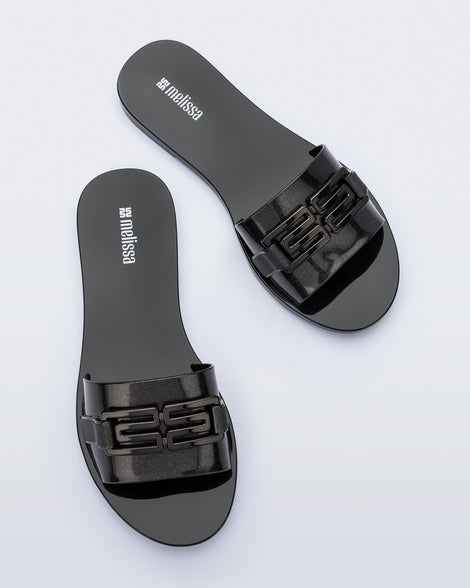 Top view of a pair of black Babe M Chic slide sandals