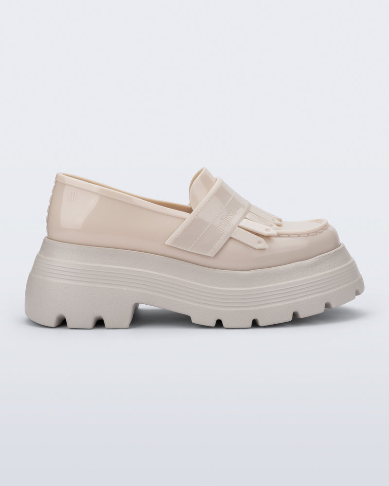 Side view of a beige Royal Plus platform loafer