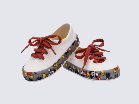 Angled view of a pair of white Street Mickey & Friends baby sneaker with red shoe laces