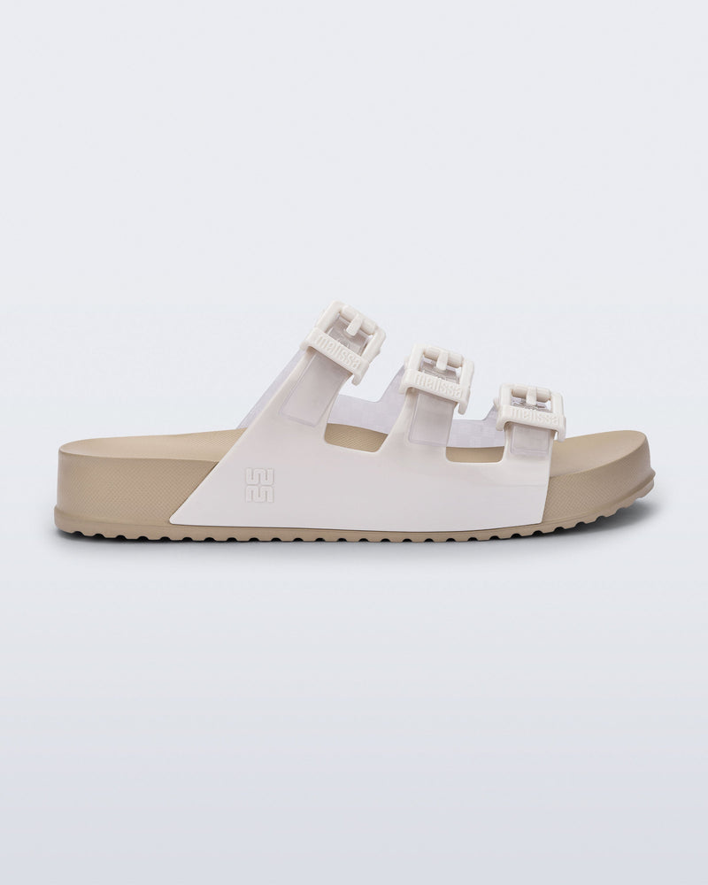 Side view of a beige Cozy Stripes sandal with white upper with 3 buckles
