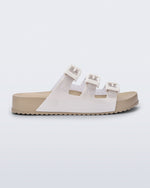 Side view of a beige Cozy Stripes sandal with white upper with 3 buckles