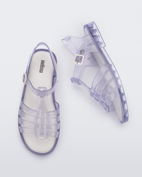 Top and side view of a pair of clear Possession Fresh fisherman style sandals with open toe.