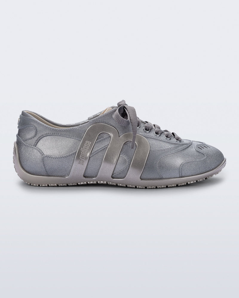 Side view of a silver Motion sneaker with grey laces