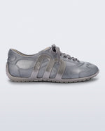 Side view of a silver Motion sneaker with grey laces