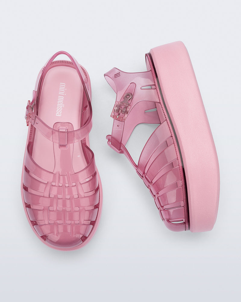 Top and side view of a pair of pink Possession Platform kids fisherman sandals