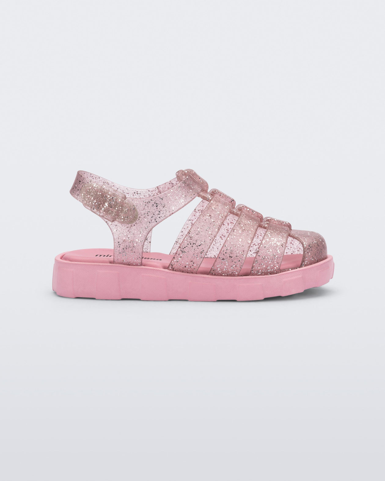 Side view of a glitter pink Megan baby sandal.