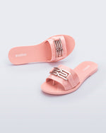Top and angled view of a pair of pink Babe M Chic slide sandals