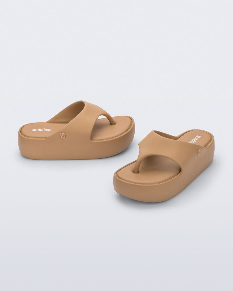 Side and angled view of a pair of green Free Platform Thong flip flops