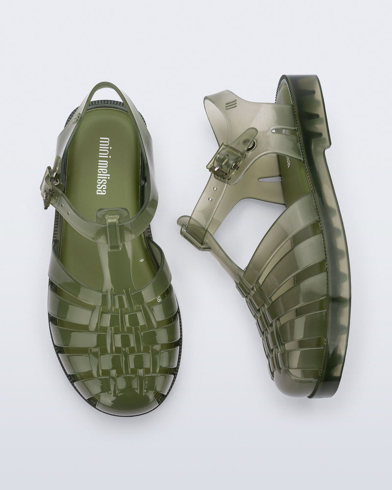 Side and top view of a pair of transparent green Possession kids sandals
