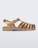 Side view of a gold Possession fisherman sandal