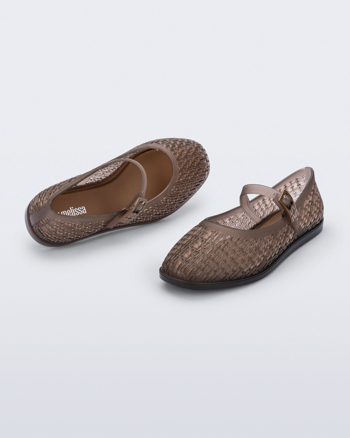 Top and angled view of a pair of transparent brown Harper flats