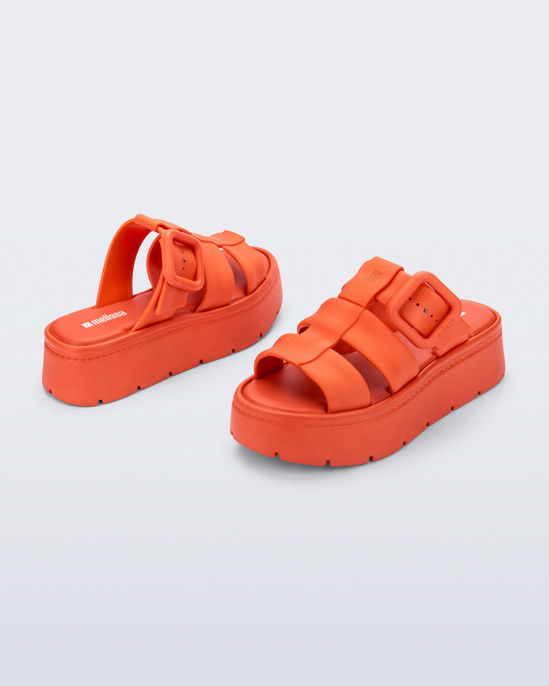 Back and angled view of a pair of orange Pump Platform sandals