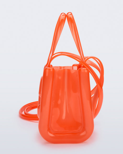 Side view of the orange Small Jelly Shopper x Telfar bag