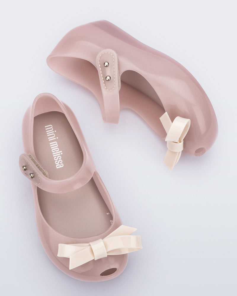 Top and angled view of a pair of pink baby Ultragirl Bow flat