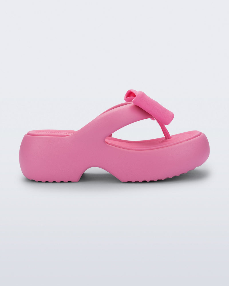 Side view of a pink Free Fuzzy Platform flip flop