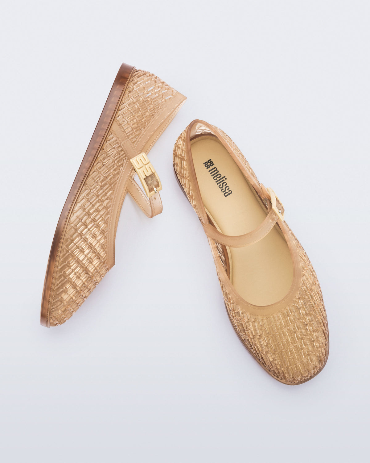 Top and side view of a pair of clear beige Harper flat with strap