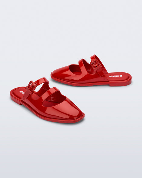 Side and angled view of a pair of red Anastasia mule slides