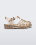 Side view of a glitter beige baby Possession sandal