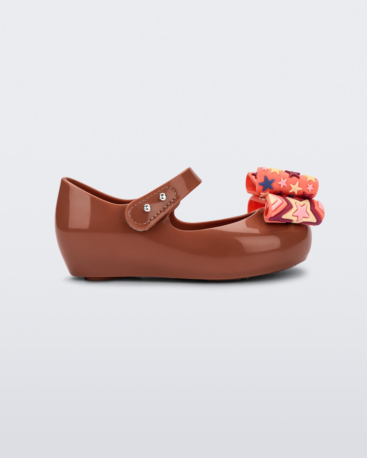 Side view of a brown with orange patterned bow Ultragirl Wonderland baby flat