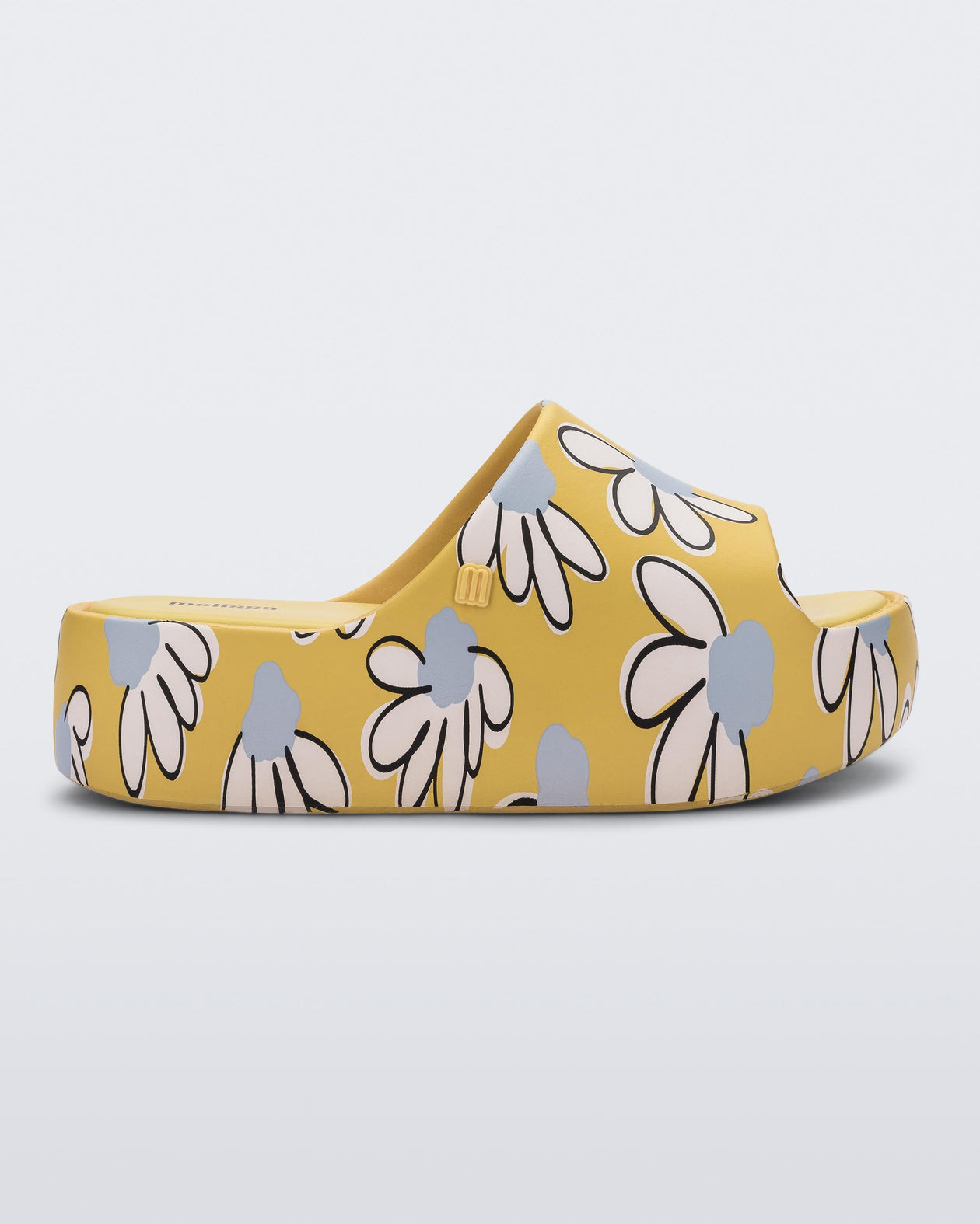 Side view of a yellow Free Print Platform slide with a white and blue flower print.