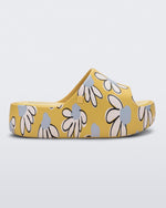 Side view of a yellow Free Print Platform slide with a white and blue flower print.