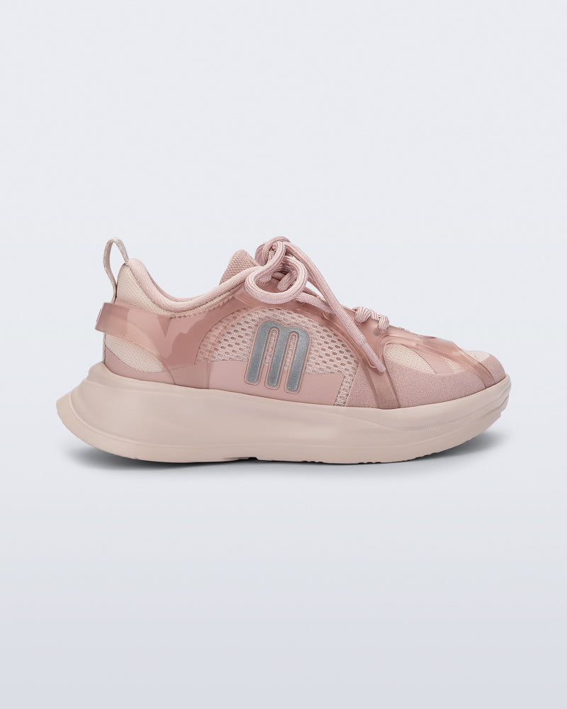 Side view of a pink X Beat kids sneaker