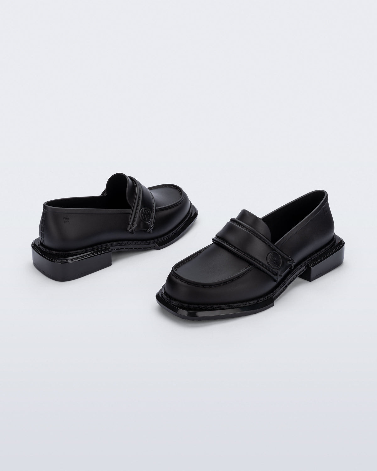 Back and angled view of a pair of black Spencer loafers