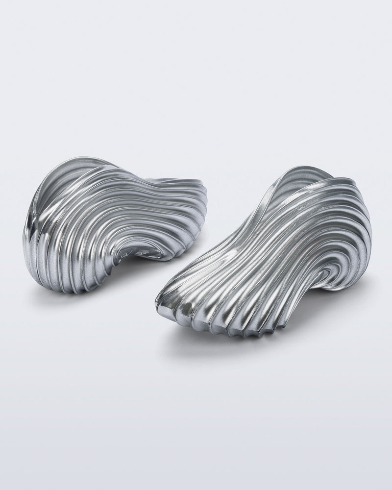 Side and back angled view of a pair of silver Quantum Sneakers