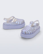 Back and angled view of a pair of pearly blue Possession Platform kids fisherman sandals with lilac soles