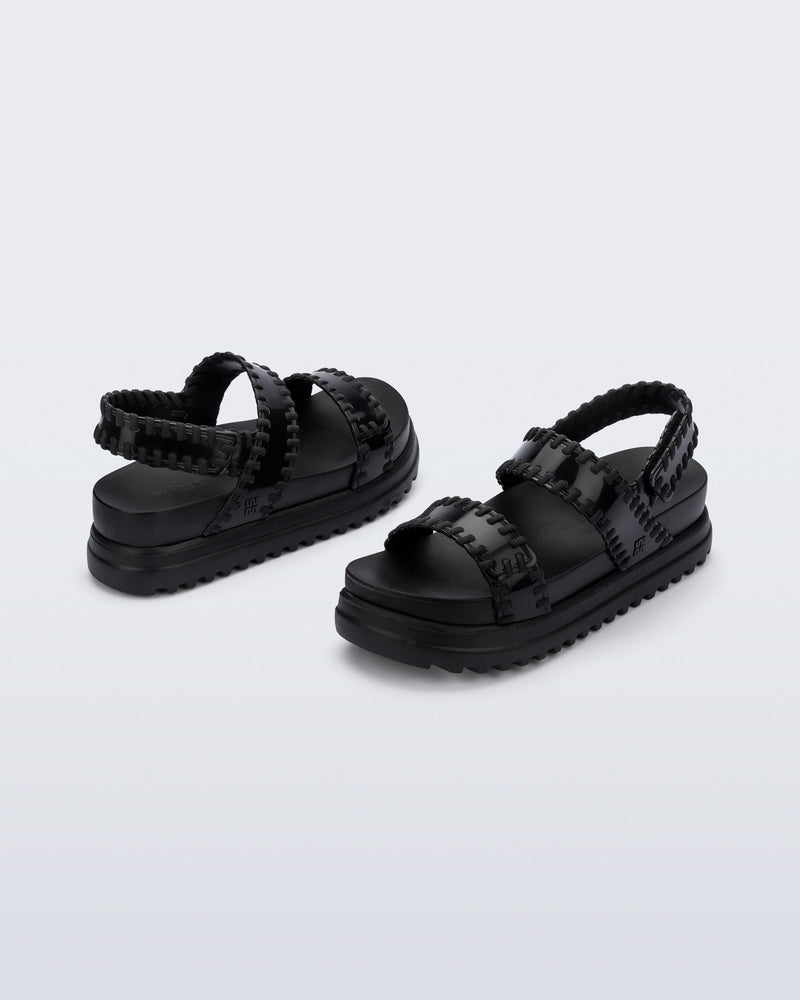 Back and angled view of a pair of black Dune Platform Sandals with faux stitching on the straps