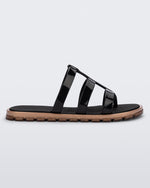 Side view of a black Path adult sandal with gold sole