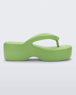 Side view of a Melissa Free platform flip flop in lime green with grey sole