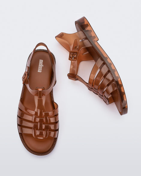 Top and side view of a pair of transparent brown Possession Fresh fisherman style sandals with open toe.