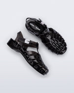 Side and top view of a pair of black Possession Pescura + Scholl fisherman sandals