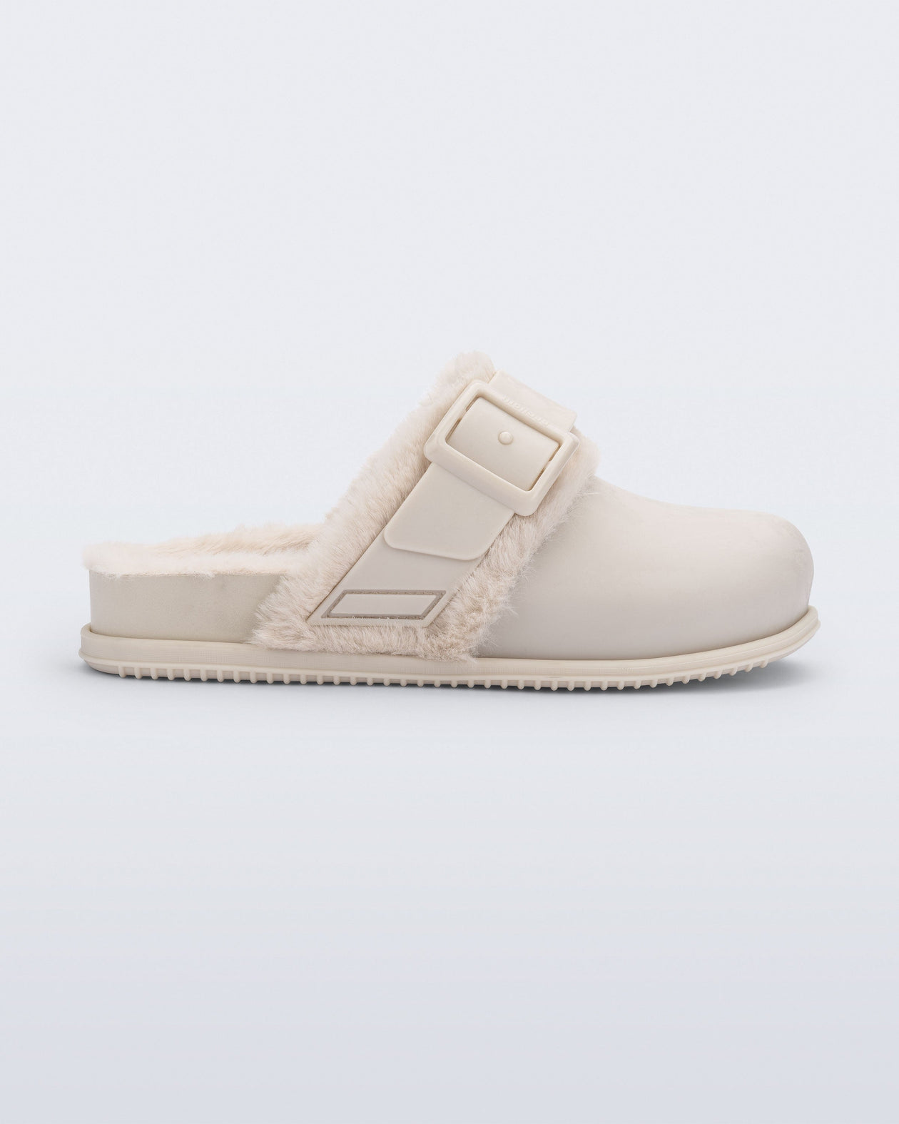Side view of a beige Cozy Warm clog with fuzzy insole