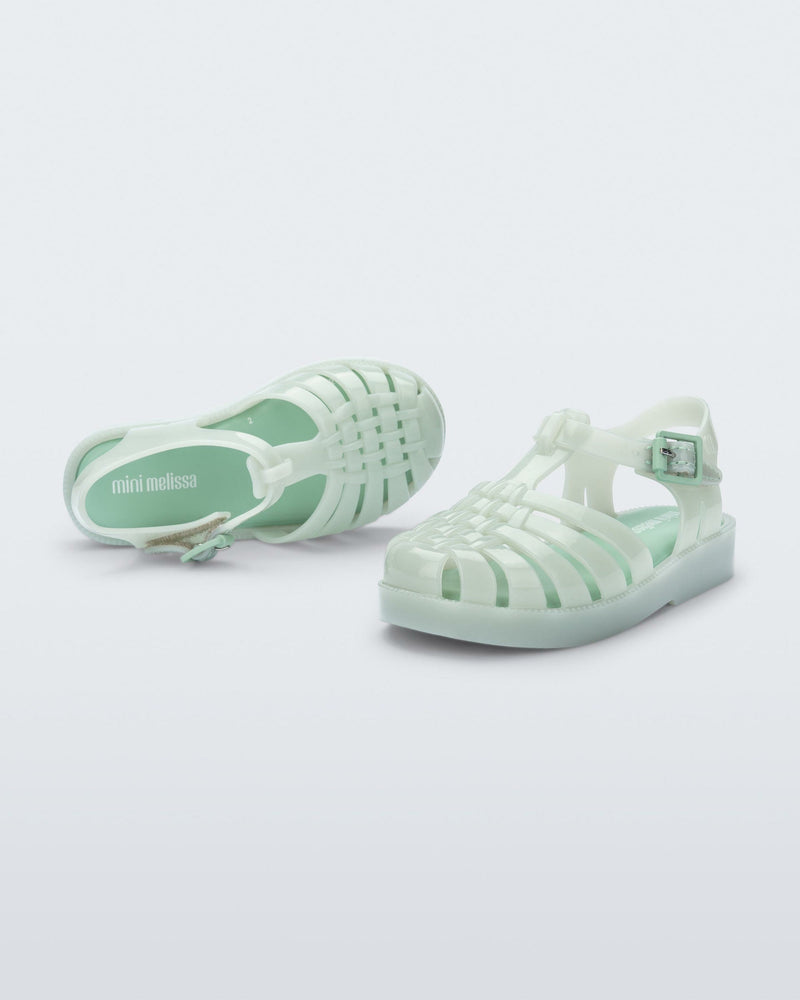 Top and side view of a pair of light green baby Possession sandals.