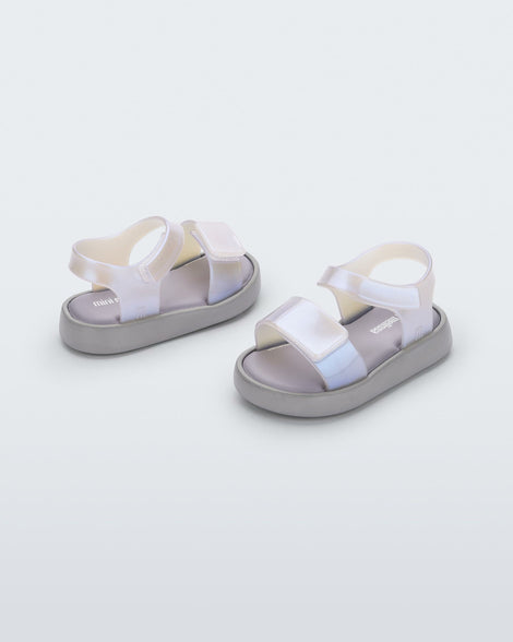 Angled view of a pair of pearly blue Mini Melissa Jump baby sandal.
