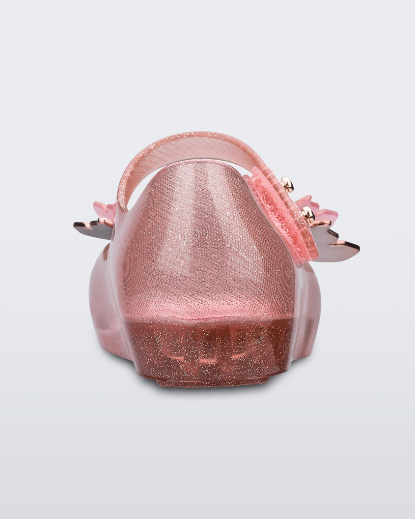 Back view of a glitter clear pink Mini Melissa Ultragirl Butterfly baby mary jane flat with two metallic and clear butterflies and peep toe.