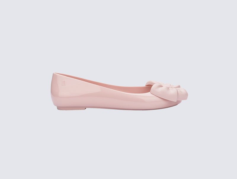 Side view of a pink Sweet Love flat with bow on top