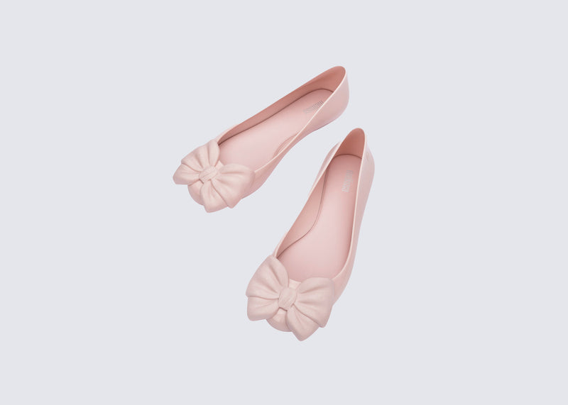 Top view of a pair of pink Sweet Love flats with bow on top