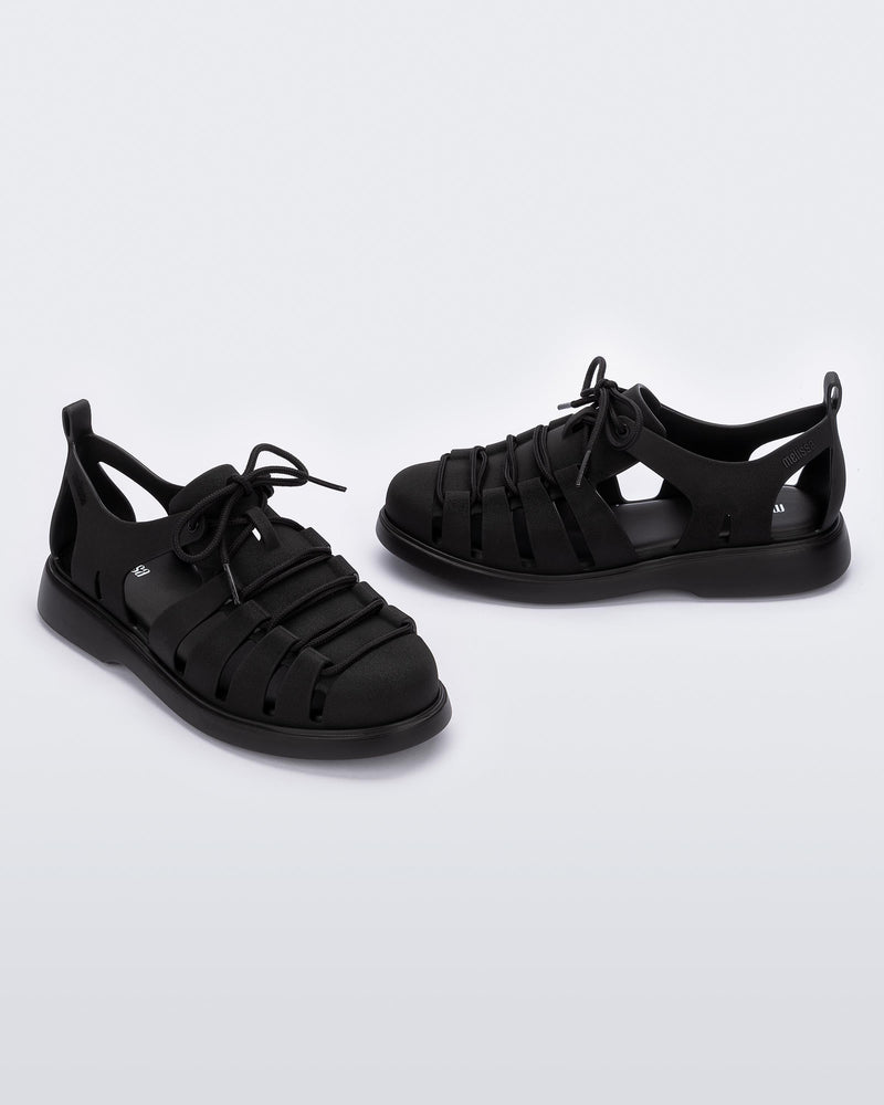 Side and angled view of a pair of black Match sneaker sandals
