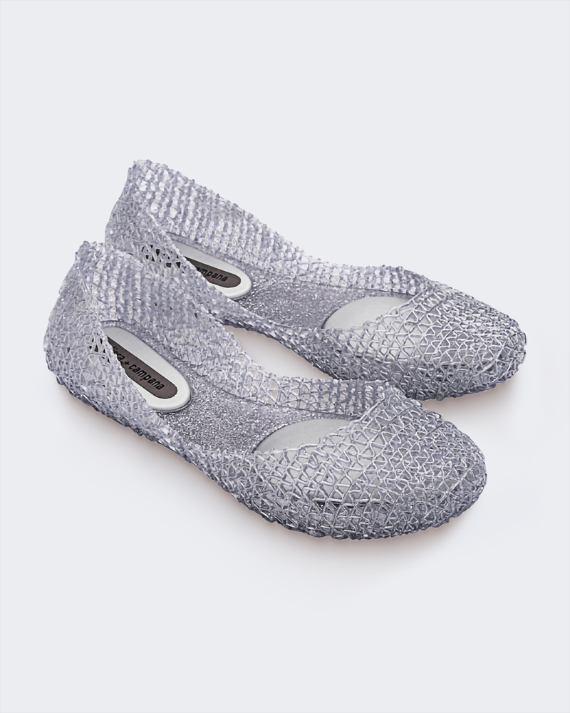 Angled view of a pair of Melissa Campana flats in clear