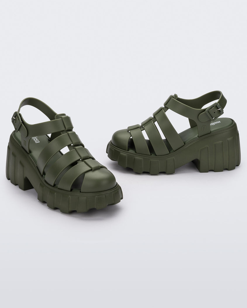 Angled view of a pair of dark green Melissa Megan Platform heels.