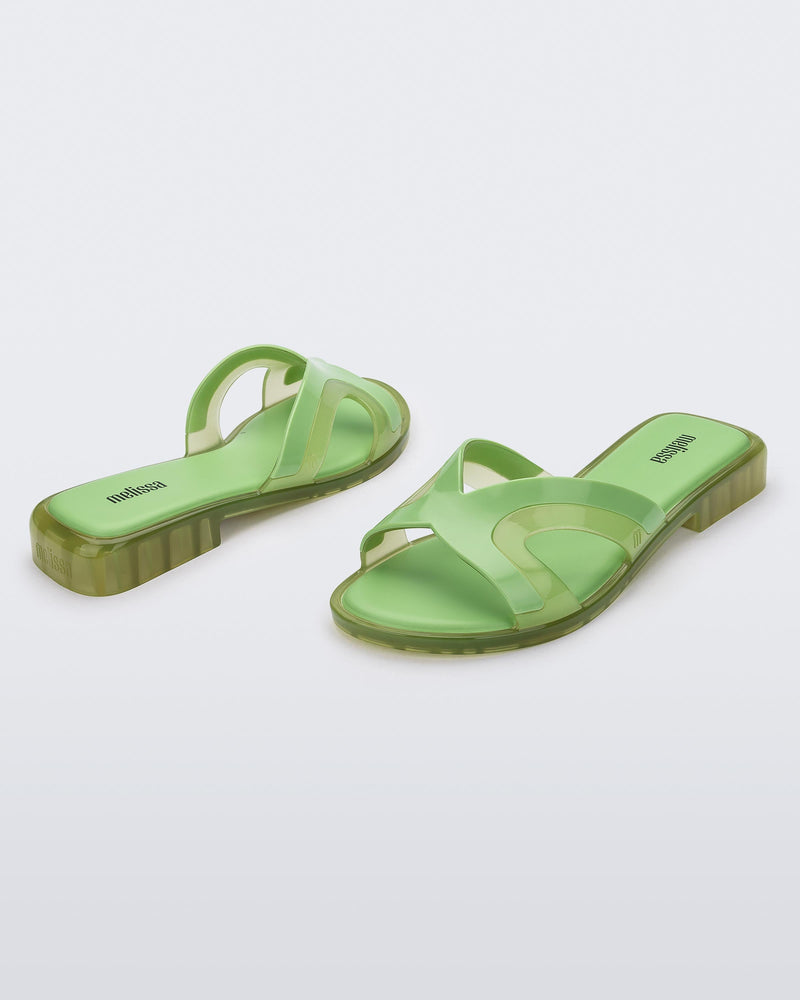 Angled front and back view of a pair of green Melissa Yacht slides.