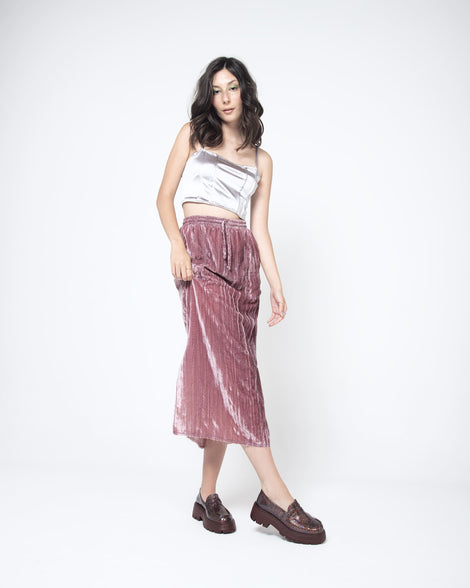A model posing wearing a pair of Melissa Royal loafers in glitter multicolor with a brown platform sole.